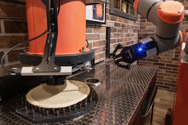 PARIS, FRANCE - JULY 09: A dough ball is flattened into a pizza base at Paris' first robotic pizzeri...