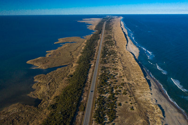 Drone aerial view of Outer Banks Highway 12 with Atlantic Ocean and Sound on both sides, Cape Hatera...