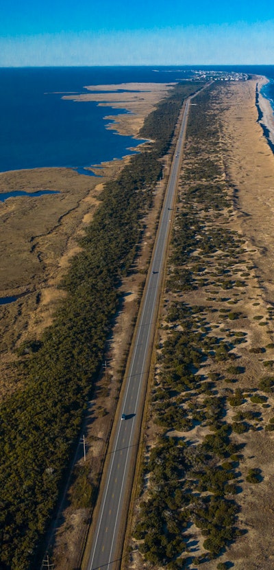 Drone aerial view of Outer Banks Highway 12 with Atlantic Ocean and Sound on both sides, Cape Hatera...