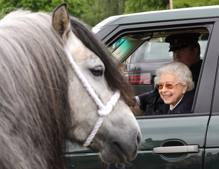 WINDSOR, ENGLAND - MAY 13: Queen Elizabeth II watches the horses from her Range Rover at The Royal W...