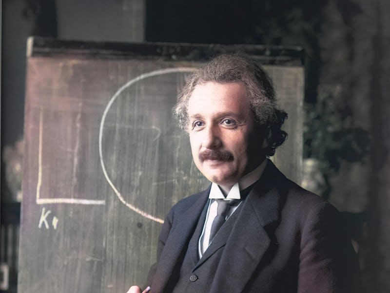 Half-length portrait of scientist Albert Einstein standing at chalkboard, 1921. Note: Image has been...