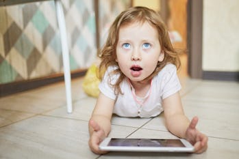 Little girl learning using digital tablet