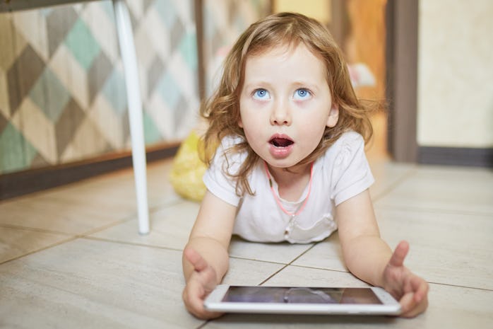 Little girl learning using digital tablet