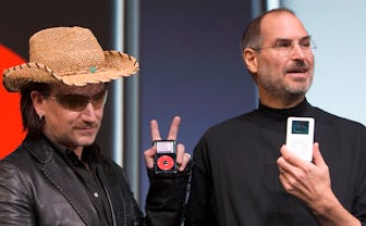 Bono, left, of the band U2, and Apple Computers Inc. Chief Executive Steve Jobs, right, hold up Appl...
