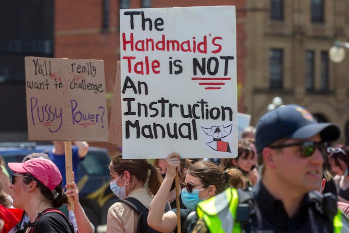 Pro-choice counter-protesters hold signs on the sidelines of the pro-life National March for Life in...