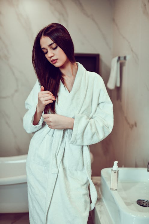 Relaxed Female Taking Care Of Hair Health After Bath