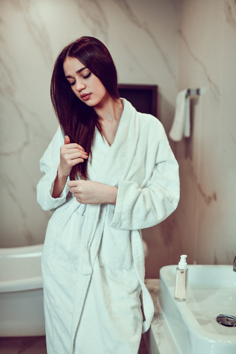 Relaxed Female Taking Care Of Hair Health After Bath