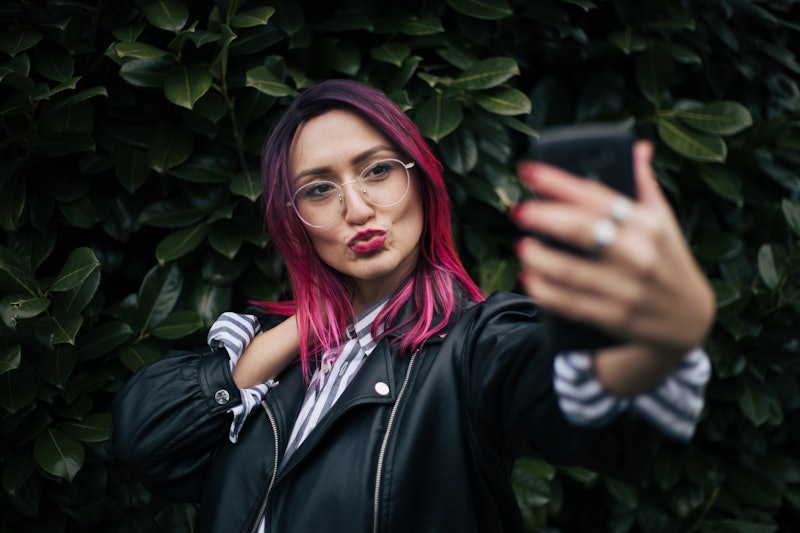 woman with pink hair taking a selfie 