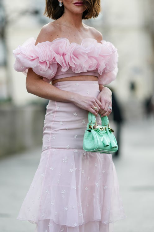 PARIS, FRANCE - MARCH 07: Alexandra Pereira wears silver and rhinestones earrings, a pale pink ruffl...