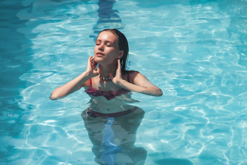 Portrait young woman relaxing in swimming pool. Cute female closed eyes, resting in swimming pool on...