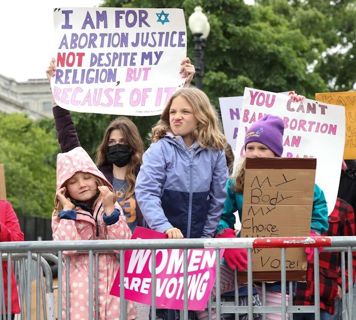 WASHINGTON, DC - MAY 08: Marchers hold up signs during a Mothers Day rally in support of Abortion ri...