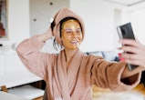 A beautiful woman with sheet mask onto her face taking a selfie. Here's how to add music to an insta...