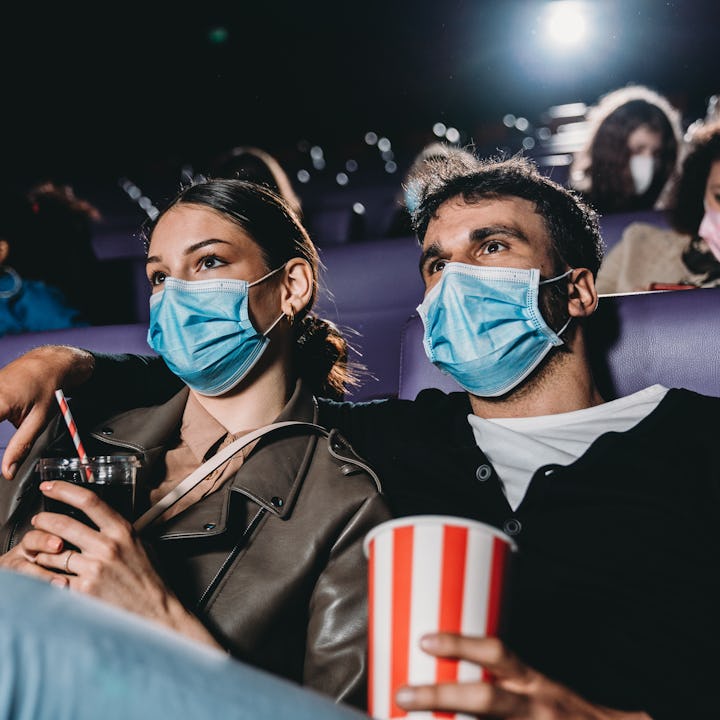 A couple in a movie theater during Covid. A man took to Reddit's AITA to ask if he was a jerk for bu...