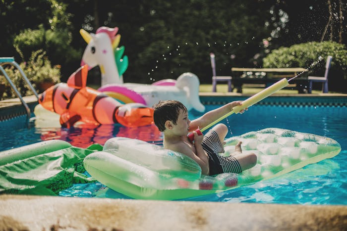 boy playing with pool floats, how to store pool floats