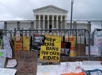 Abortion rights demonstrators leave banners at a fence outside of the US Supreme Court in Washington...