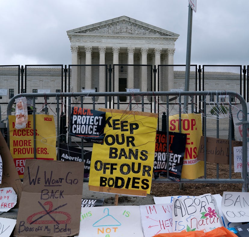 Abortion rights demonstrators leave banners at a fence outside of the US Supreme Court in Washington...