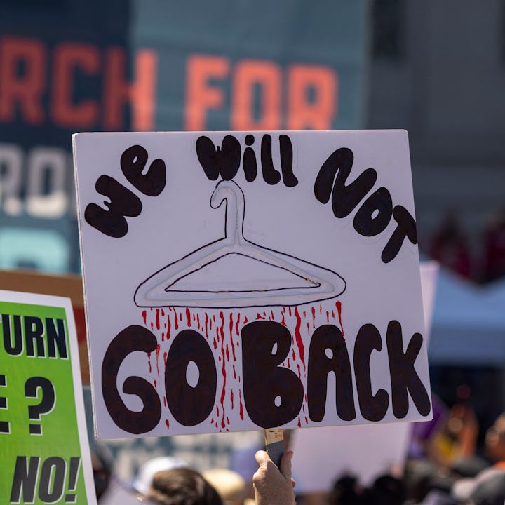 People hold signage at one of the Bans Off Our Bodies abortion rights protests. Companies like Starb...