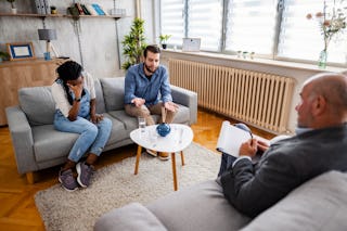 A couple speaks with a mediator to discuss divorce.