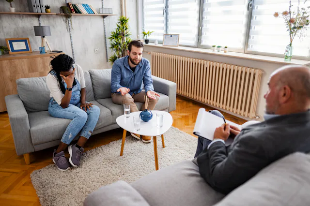 A couple speaks with a mediator to discuss divorce.