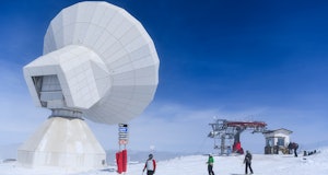 SIERRA NEVADA, SPAIN - MARCH 05:  People ski past the IRAM 30m Radio Telescope at Sierra Nevada sky ...