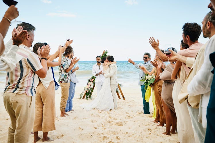 A couple having a destination wedding adds to how much it costs to attend a wedding in 2022.
