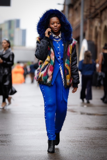SYDNEY, AUSTRALIA - MAY 12: A guest wearing blue shirt and pants and colour blocking fur hood jacket...