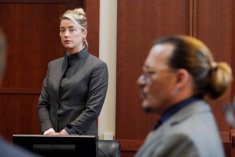 Actors Amber Heard and Johnny Depp watch as the jury leave the courtroom for a lunch break at the Fa...