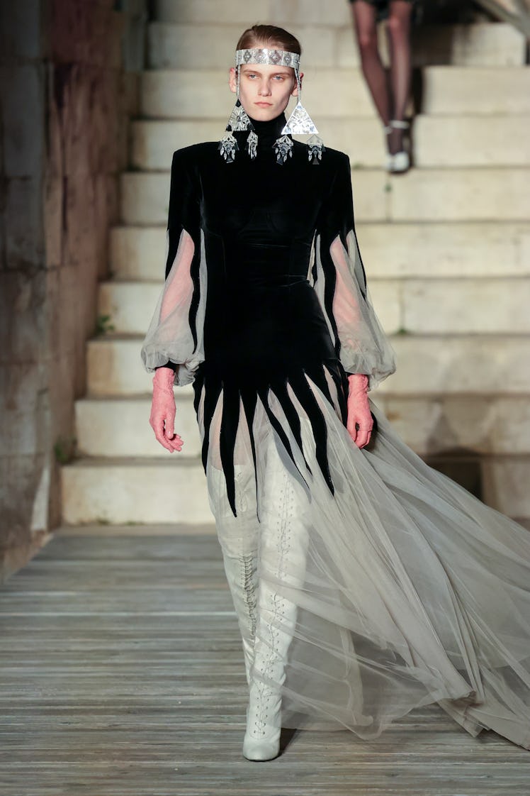 A model walking the runway during Gucci Cosmogonie at Castel Del Monte in a black and white gown