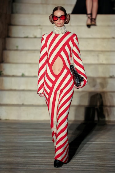 A model walking the runway during Gucci Cosmogonie at Castel Del Monte in a red and white overall