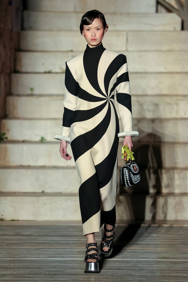 A model walking the runway during Gucci Cosmogonie at Castel Del Monte in a black and white overall