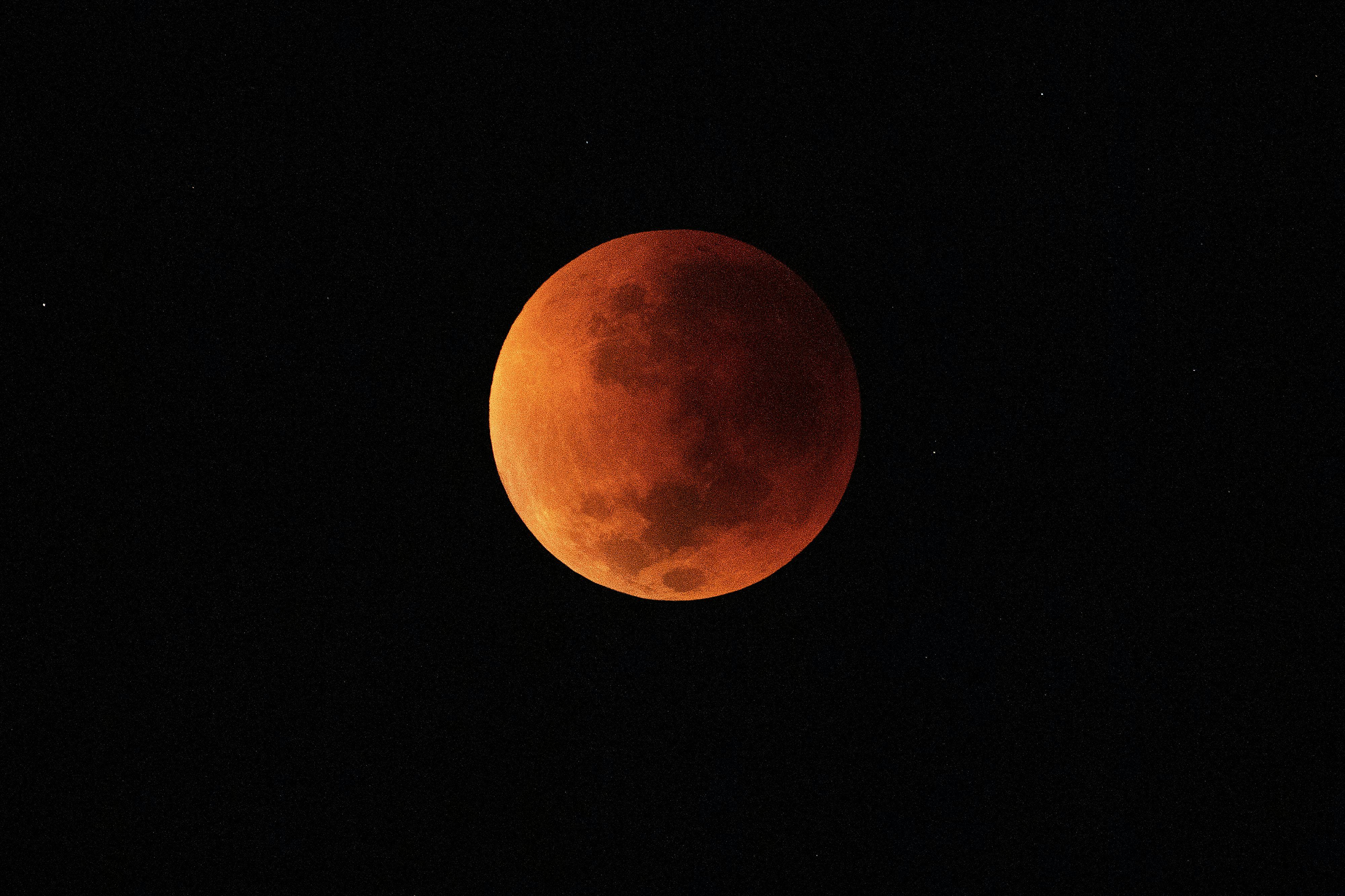 TOPSHOT - The blood moon is seen during a total lunar eclipse in Rio de Janeiro on May 16, 2022. (Ph...