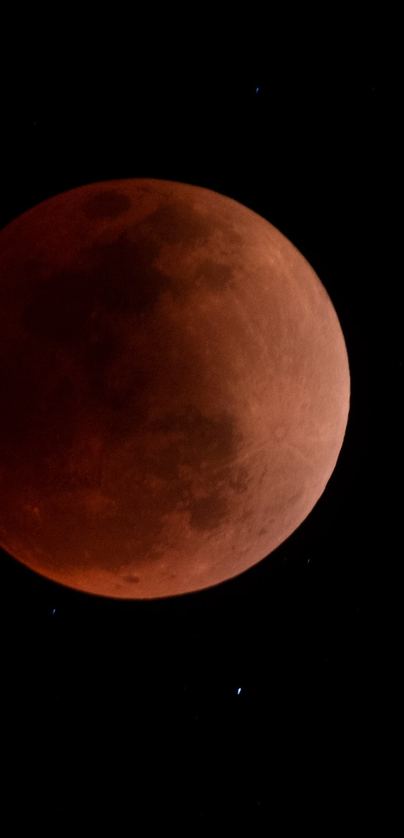 The blood moon is seen during a total lunar eclipse in Canta, east of Lima on May 15, 2022. (Photo b...