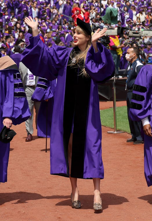 Before Taylor Swift's NYU graduation speech, she greeted fans and fellow grads. Photo via Getty Imag...
