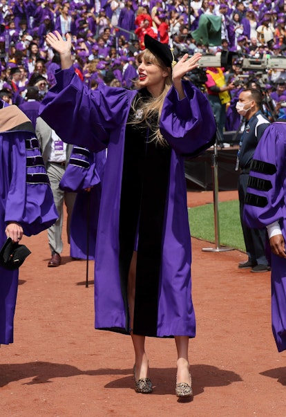 Before Taylor Swift's NYU graduation speech, she greeted fans and fellow grads. Photo via Getty Imag...
