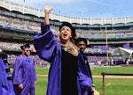 Singer Taylor Swift waves at graduating students during New York University's commencement ceremony ...
