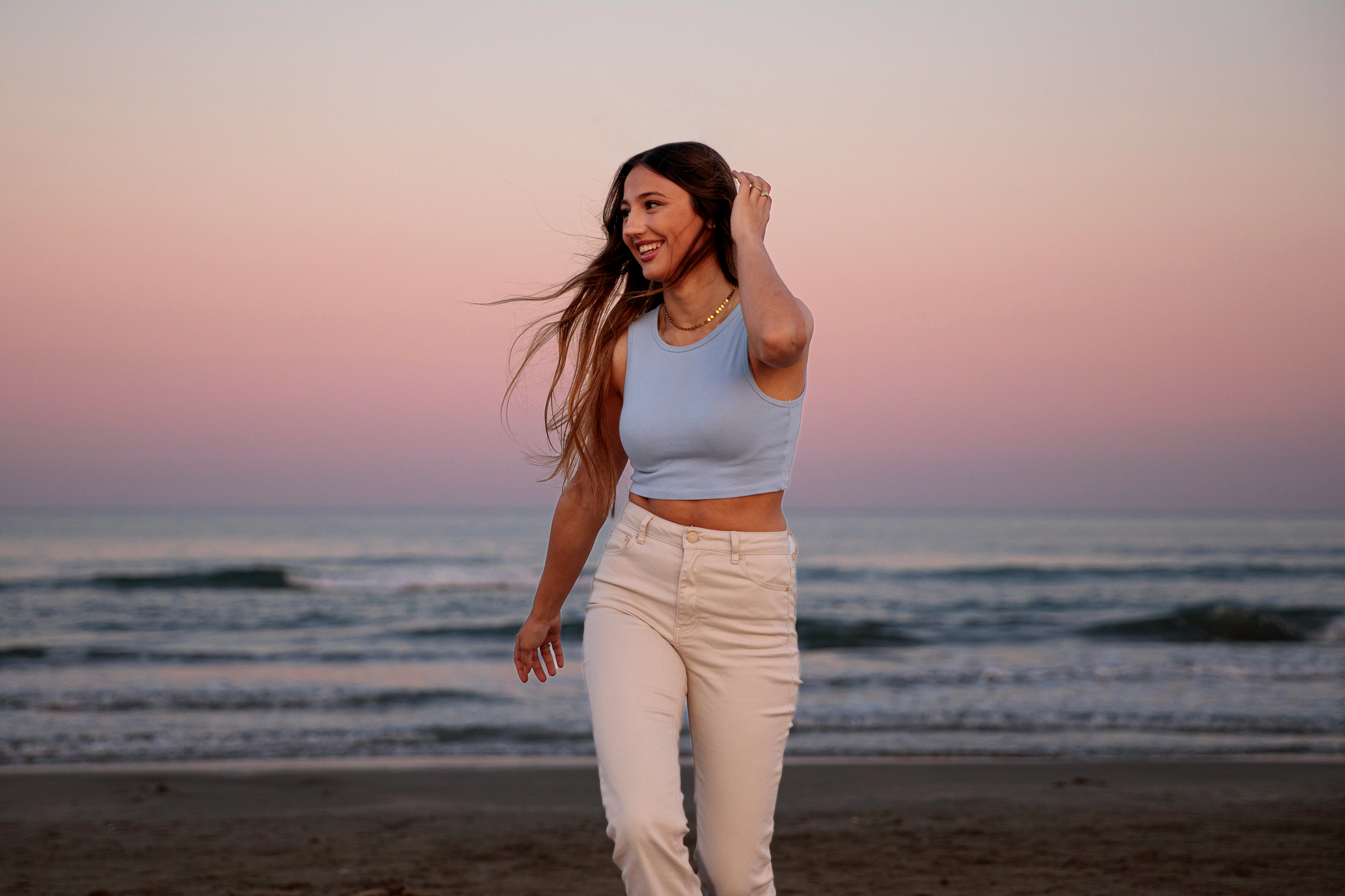 A woman at the beach at dusk. Gemini season 2022 do's and don'ts.