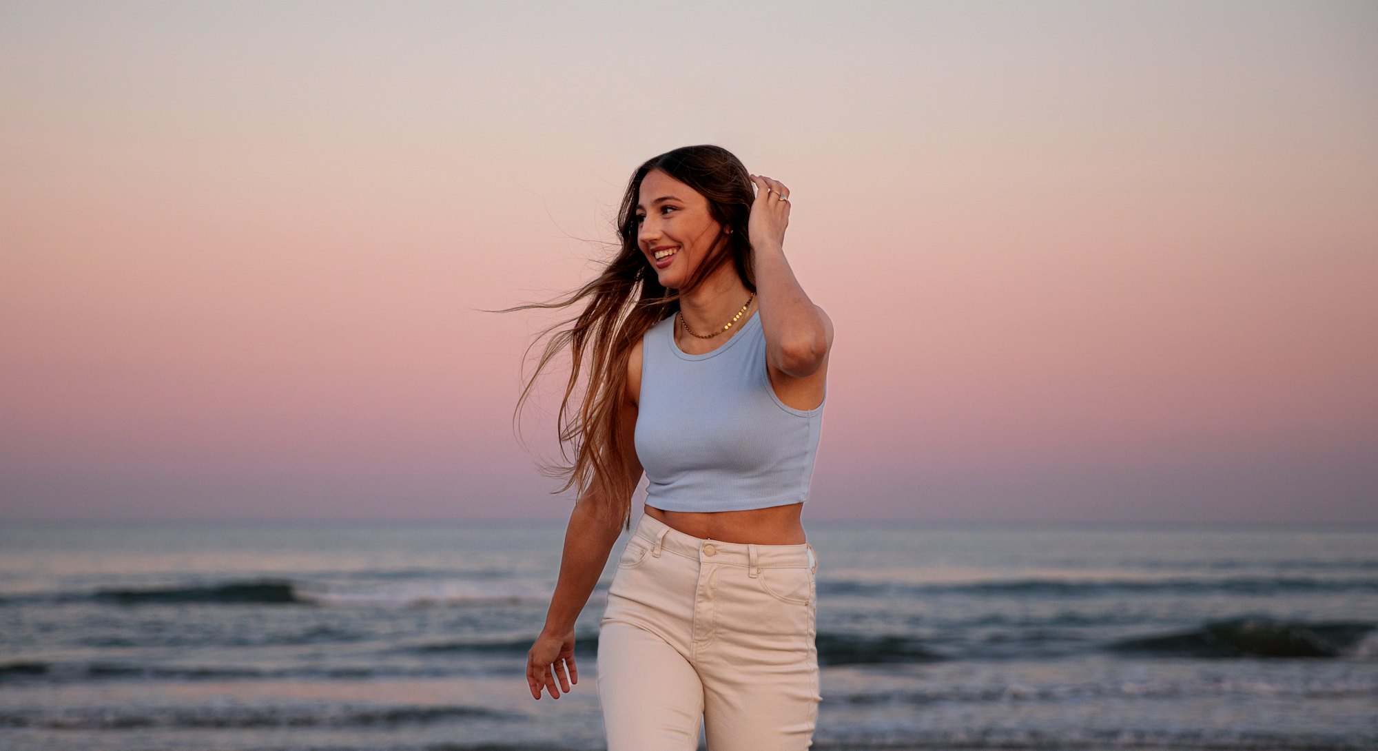 A woman at the beach at dusk. Gemini season 2022 do's and don'ts.