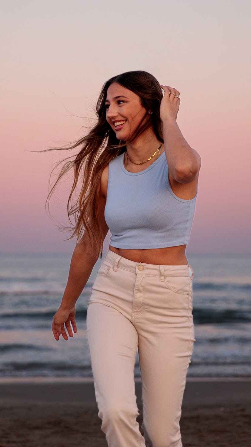 A woman at the beach at dusk. Gemini season 2022 do's and don'ts.