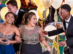 A group of friends use instagram captions for prom for pictures at their school dance.