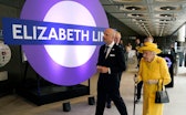 TOPSHOT - Britain's Queen Elizabeth II (R) visits Paddington Station in London on May 17, 2022, to m...
