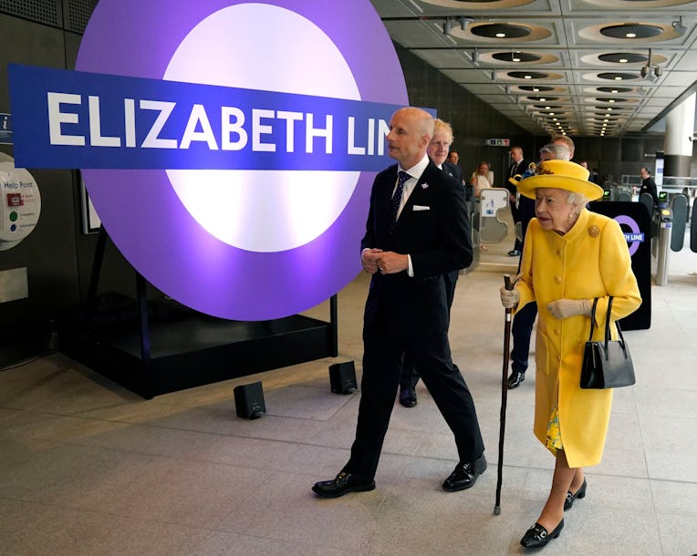 TOPSHOT - Britain's Queen Elizabeth II (R) visits Paddington Station in London on May 17, 2022, to m...