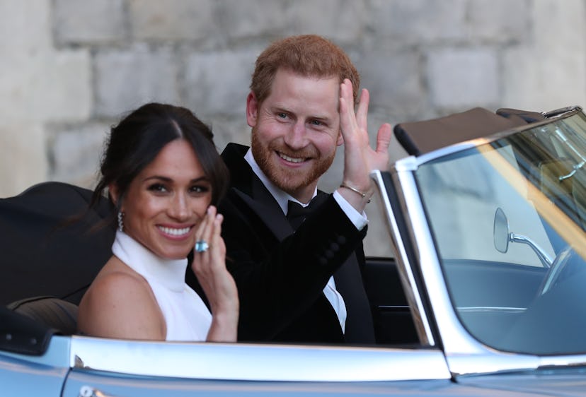 Duchess of Sussex and Prince Harry, Duke of Sussex wave as they leave Windsor Castle after their wed...