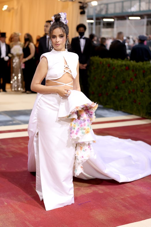 Camila Cabello attends The 2022 Met Gala Celebrating in a white crop top and skirt