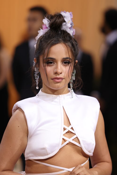 Camila Cabello attends The 2022 Met Gala in a white crop top and matching skirt