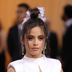 Camila Cabello attends The 2022 Met Gala in a white crop top and matching skirt