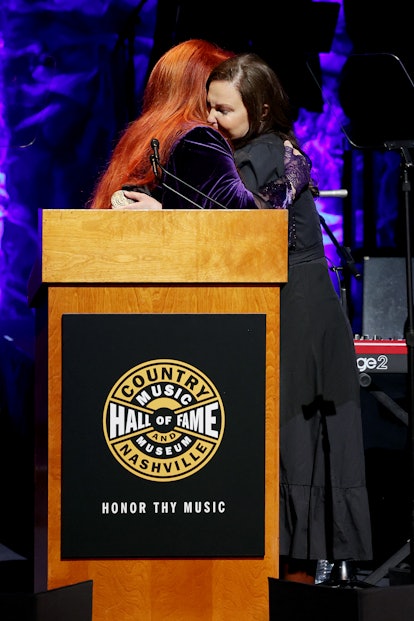 NASHVILLE, TENNESSEE - MAY 01: (L-R) Inductee Wynonna Judd and Ashley Judd speak onstage for the cla...