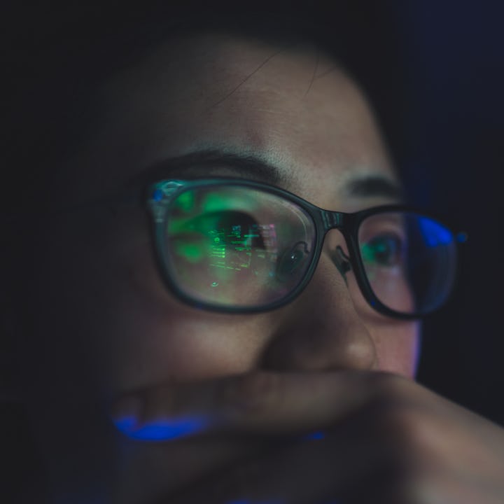 A woman looking concerned at her computer. AP just released data of an algorithm used by child servi...