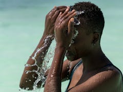Black skin girl in turquoise water