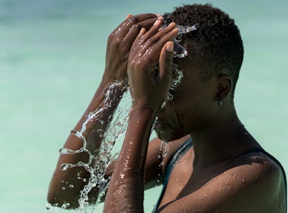 Black skin girl in turquoise water