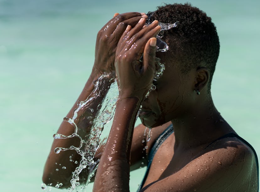 Black skin girl in turquoise water